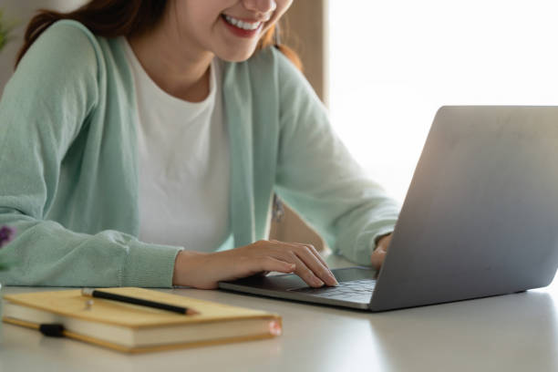 istock E-learning ,online ,education and internet social distancing protect from COVID-19 viruses concept. Asian woman student video conference e-learning with teacher on laptop computer at home. 1402142501