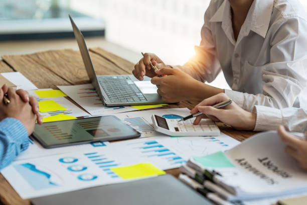 istock Group of IT consultant working by digital tablet and management big data and analyze financial document of company. 1402143232