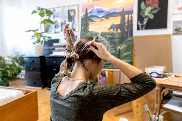 istock Young painter creates in her studio at home stock photo 1402143603