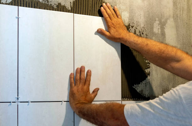 istock Ceramic tile. The tiler lays ceramic tiles on adhesive... 1402146579