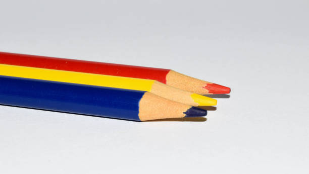 istock Colored pencils background. Color pencils on white background. Romanian flag 1402147470
