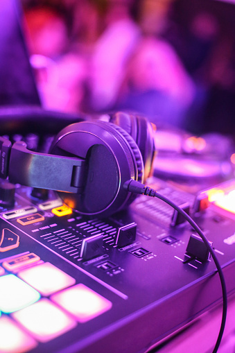 Clubbing and nightlife - turntable and headphones in a nightclub.