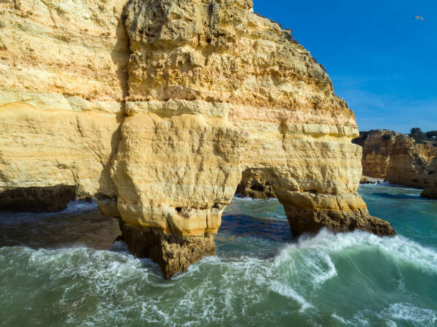 Rock cliffs and waves in Algarve Aerial view on rock cliffs and waves near Praia da Marinha in the Algarve, Portugal praia da marinha stock pictures, royalty-free photos & images