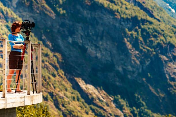 istock Tourist with camera on tripod in Norway nature 1402147557