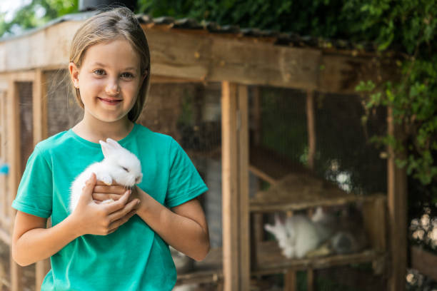 istock Girl with white rabbit in hands 1402147655