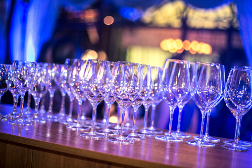 Large group of empty wineglasses in a nightclub.