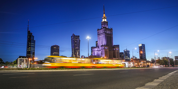 Traffic at night in front of the Palace of Culture and Science in Warsaw, Poland.