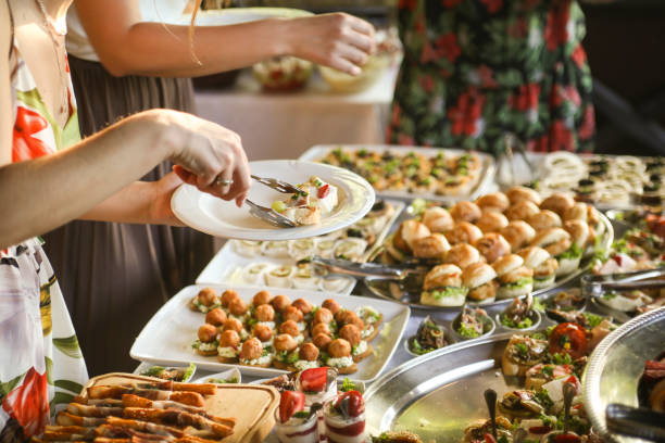 istock People choosing food from a buffet table 1402148254