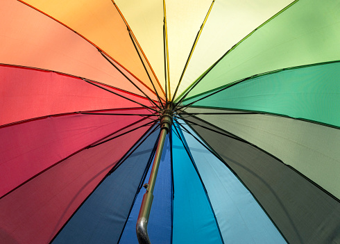New colorful dissolved umbrella with the colors of the rainbow below closeup\