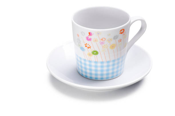 ceramic checked mug with flowers print and a saucer, isolated - two objects cup saucer isolated imagens e fotografias de stock