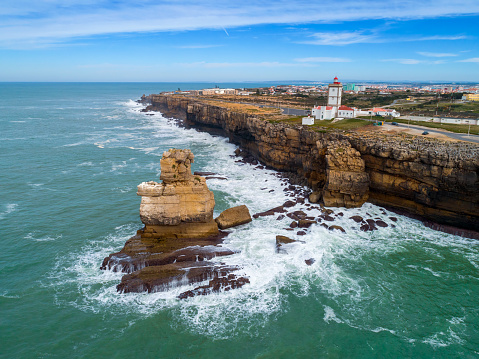 Aerial view of lighthouse on Cabo Carvoeiro and Atlantic ocean in Portugal