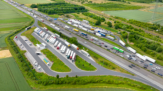 Dense traffic on highway. Rest area for cars and trucks - aerial view