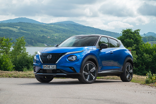 Zdiar, Slovakia - 8th June 2022: Nissan Juke Hybrid stopped on a road in mountain scenery. The Juke is one of the most popular SUV/crossover on European market.