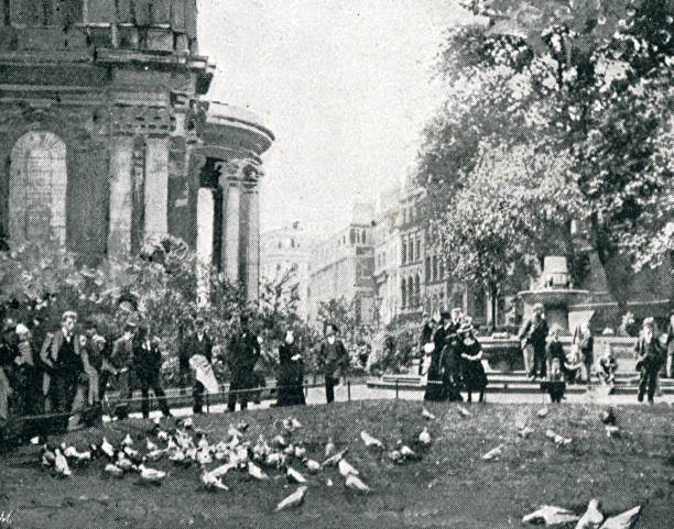 istock People feeding pigeons at the gardens at St Pauls 1402157189
