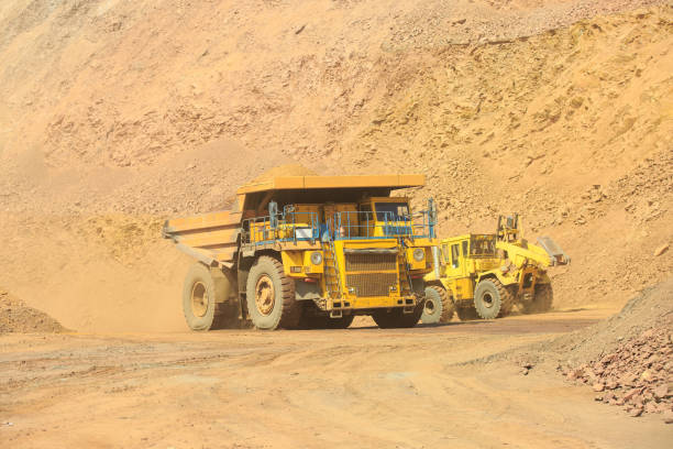 istock Quarry dump truck loaded with orange rock . 1402157274