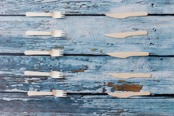 istock Flat lay composition with eco-friendly eating utensil on light blue wooden background. Kraft wood eating utensil, Recyclable, zero waste concept. Selective focus 1402157469