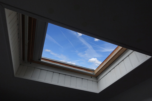 Wooden roof window  Sky view  Indoor shot on the floor of a house