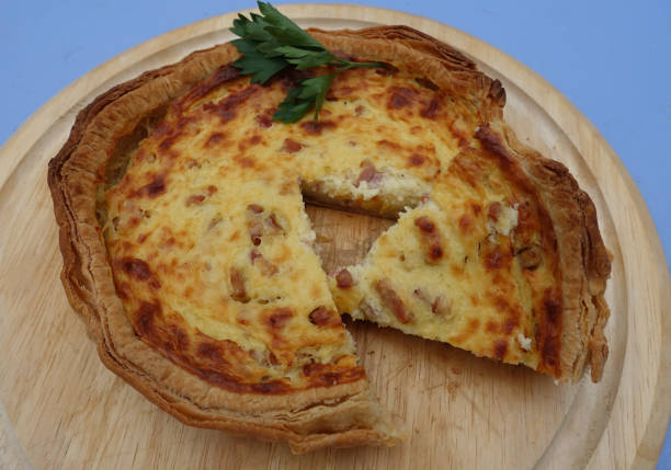 istock Portion quiche lorraine on a wooden cutting board 1402158303