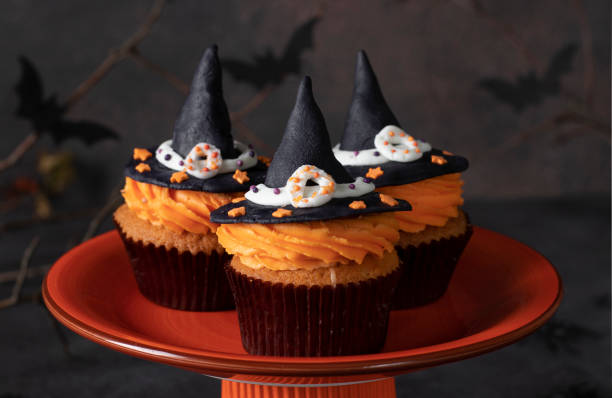 istock Halloween cupcakes decorated witch hat from mastic. Sweets for kids on Halloween party 1402163108