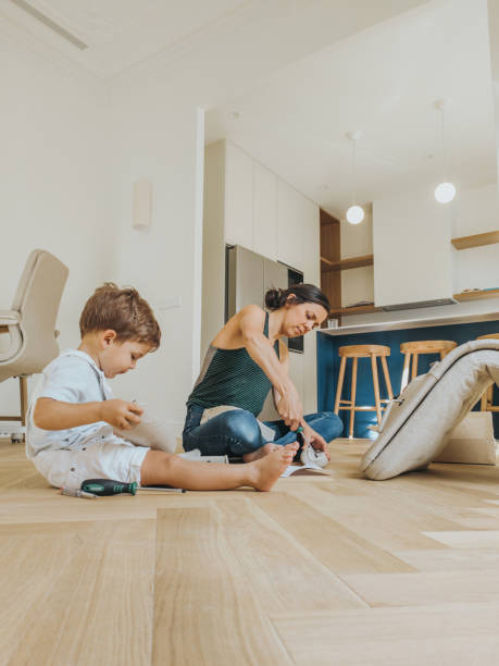 istock Woman is assembling furniture at home 1402163851
