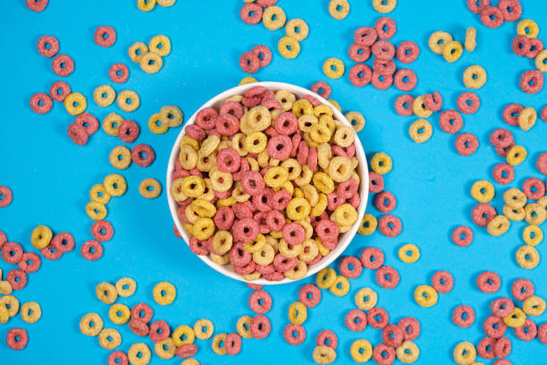 istock Corn rings of quick breakfast powder on a plate on a blue background, top view 1402164054