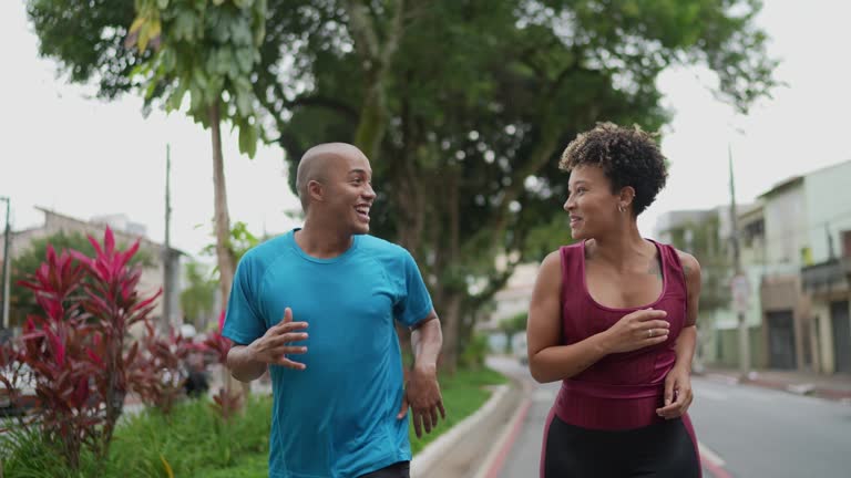 Young couple running in the street