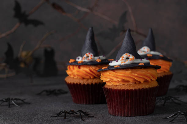 istock Halloween cupcakes decorated witch hat from mastic. Sweets for kids on Halloween party 1402169111