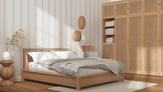 Scandinavian wooden bedroom in white and beige tones, double bed with pillows, duvet and blanket, striped wallpaper, rattan wardrobe, pendant lamps and parquet. Modern interior design