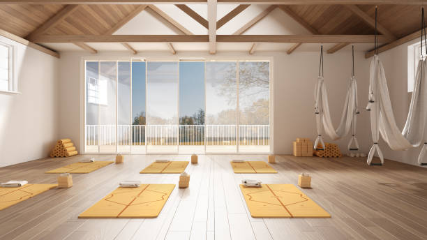 istock Empty yoga studio interior design, minimal open space with mats, hammocks and accessories, wooden floor and roof, ready for yoga practice, panoramic window with autumn panorama 1402170282
