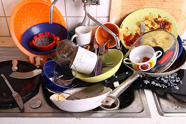 my flatmate hasn't done the chores again huge heap of dirty disgusting dishes in the sink waiting to be washed by unreliable flatmate washing dishes photos stock pictures, royalty-free photos & images