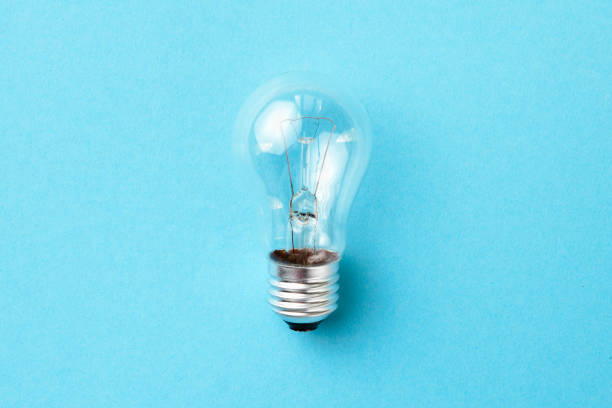 istock Incandescent lamp isolated on blue background. 1402171612
