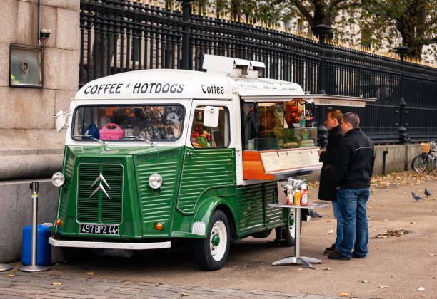 London, UK - Oct 31, 2012: Customers at vintage Citroen food truck or snack van selling hot dogs and coffee next to the British Museum