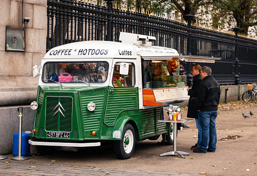 London, UK - Oct 31, 2012: Customers at vintage Citroen food truck or snack van selling hot dogs and coffee next to the British Museum