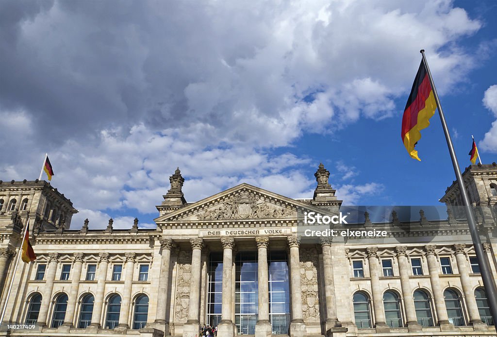 Reichstag with German flags The famous Reichstag in Berlin with German flags Ancient Stock Photo
