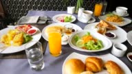 istock Lunch, branch or dinner concept. Close-up view of food on table in restaurant or cafe. Breakfast in hotel or resort. Thai cuisine. Coffee cup, orange juice, pancakes, waffles, salad, cold cut 1402175125
