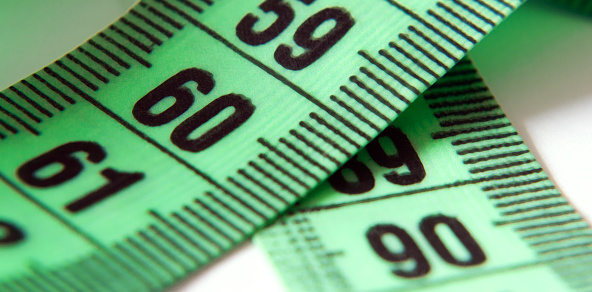 Concept of perfect size of body, health food and diet. Measuring tape with number 90-60-90