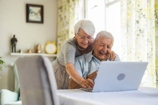 istock Happy senior couple using laptop at home 1402178538