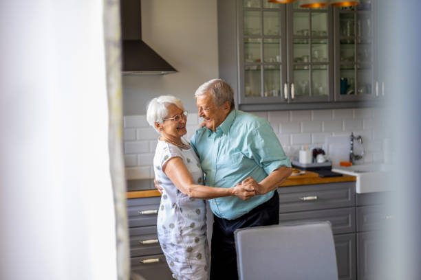 istock Senior Couple Dancing in their Kitchen 1402178673
