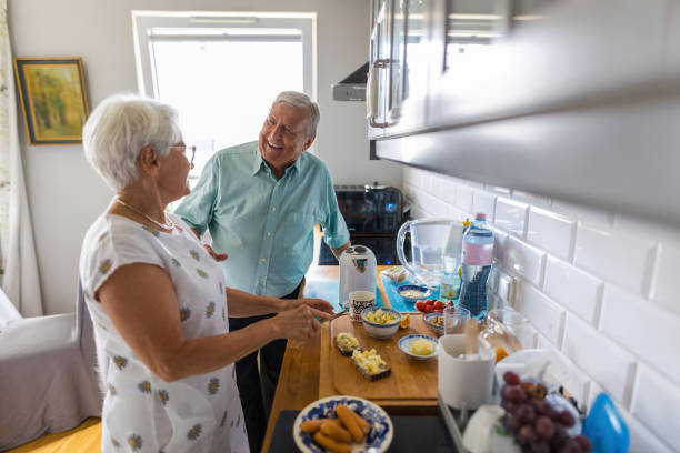 istock Senior couple in a kitchen making breakfast 1402178674