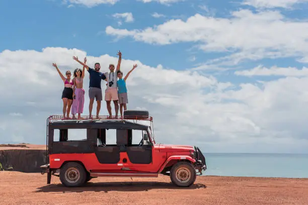 Photo of Tourists enjoying the beach in off road car