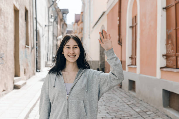 istock Pretty smiling young female walking around city 1402180877