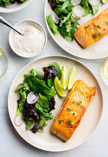 Grilled salmon fillet and fresh vegetable salad. Mediterranean diet. stock photo