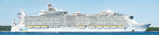 Halifax, Canada - June 7th, 2022 - The Oasis of the Seas, the fourth largest cruise ship in the world, departs from Halifax on its first trip to the city. The ship measures 360 metres in length, 18 decks tall, weighs 226,838 tonnes, and has a carrying capacity of 5,600 cruise guests, plus crew.