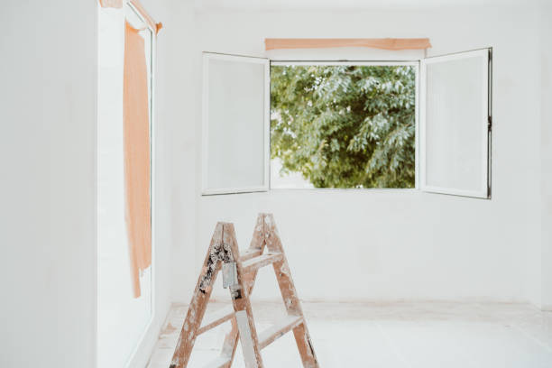 istock ladders and painter tools on white room at construction site. Painting walls. Home improvement 1402187143