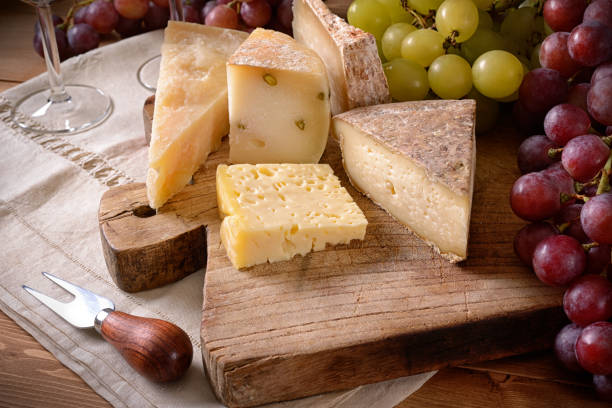 istock Cheese board with bunches of grapes, close-up. 1402189323