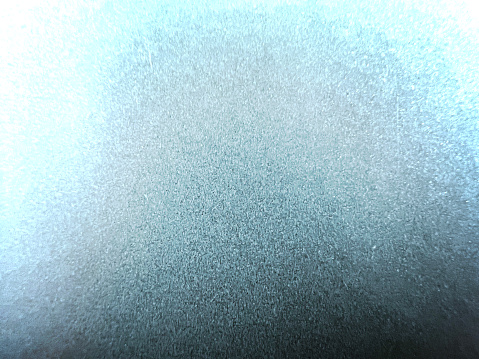 A macro image of a bluish metal.