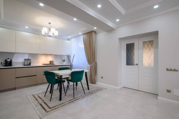 istock Modern white and beige large luxurious kitchen and dining table in studio apartment 1402190301