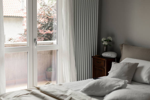 istock beautiful hotel room with a pillow bed and a large window 1402190433