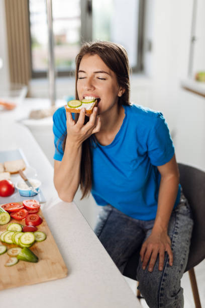 istock Woman eating a sandwich 1402190465