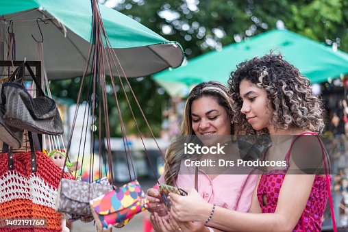 istock Mother and daughter looking at craft store 1402191760